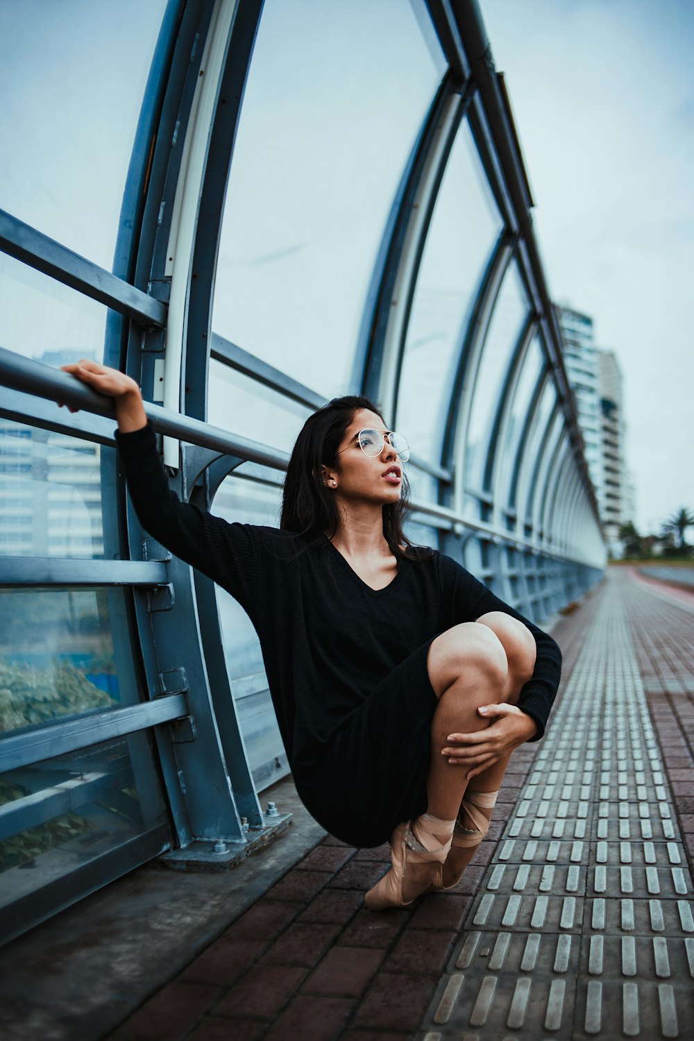 woman tip toeing beside handrails