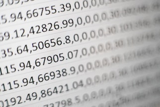 Close-up view of rows of numbers and data entries displayed in a grid format, resembling a spreadsheet or data table.