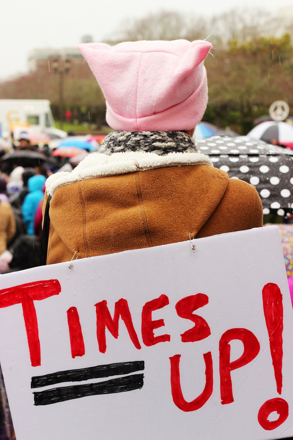 person carrying rally poster