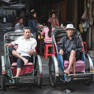 Shared ride moment inside a local market restaurant with riders and customers chatting.