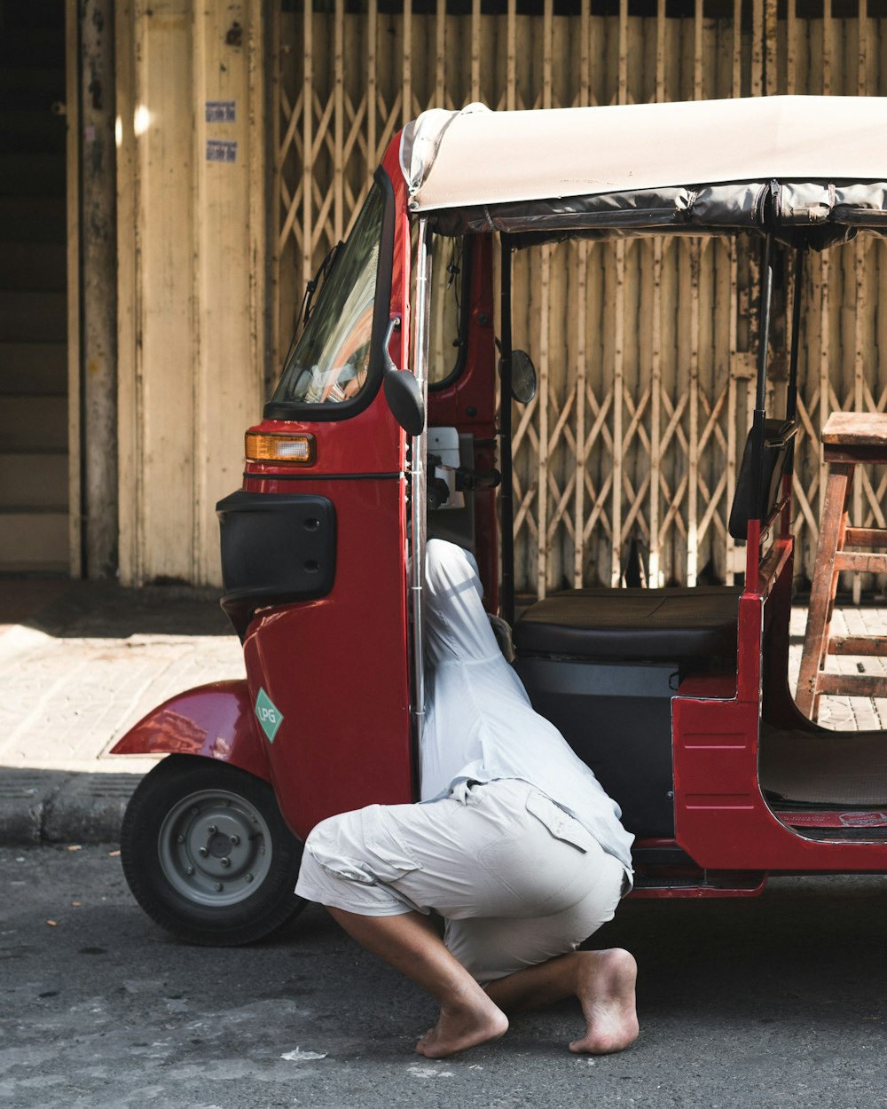 person kneeling in side cart