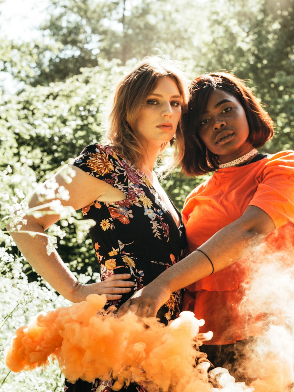 2 women in orange and black shirts