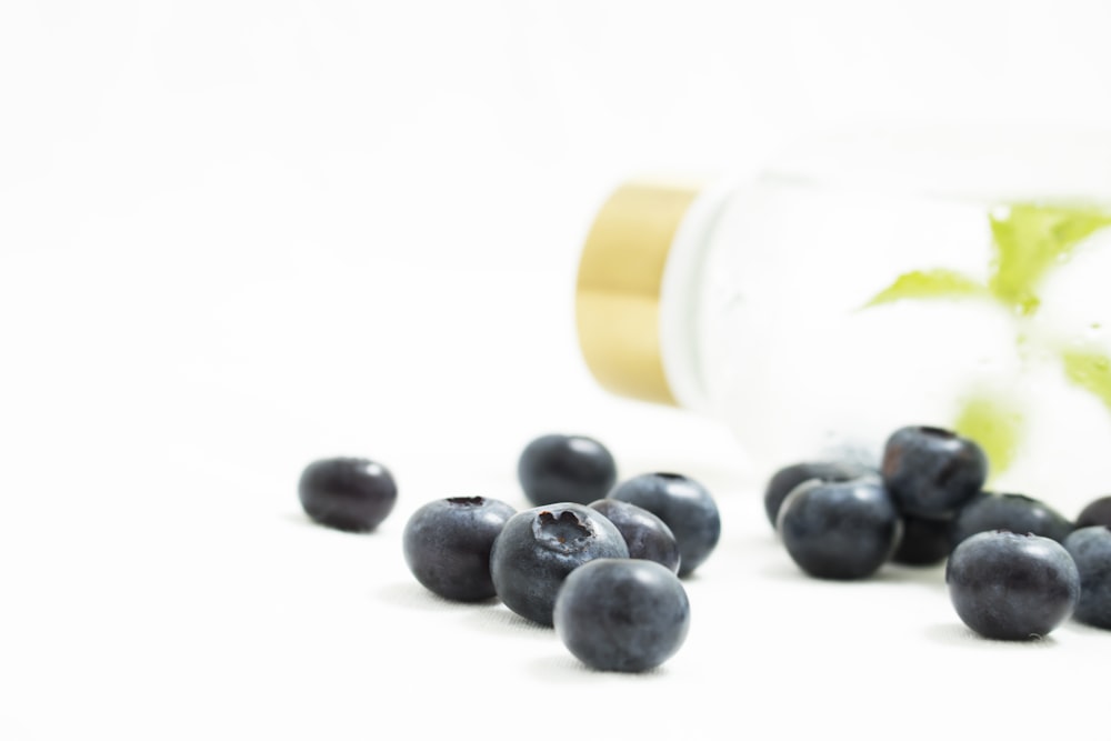 clear glass bottle near fruits