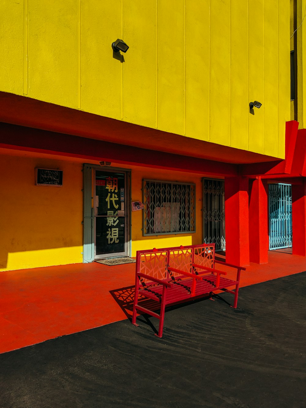 red bench in front of store facade