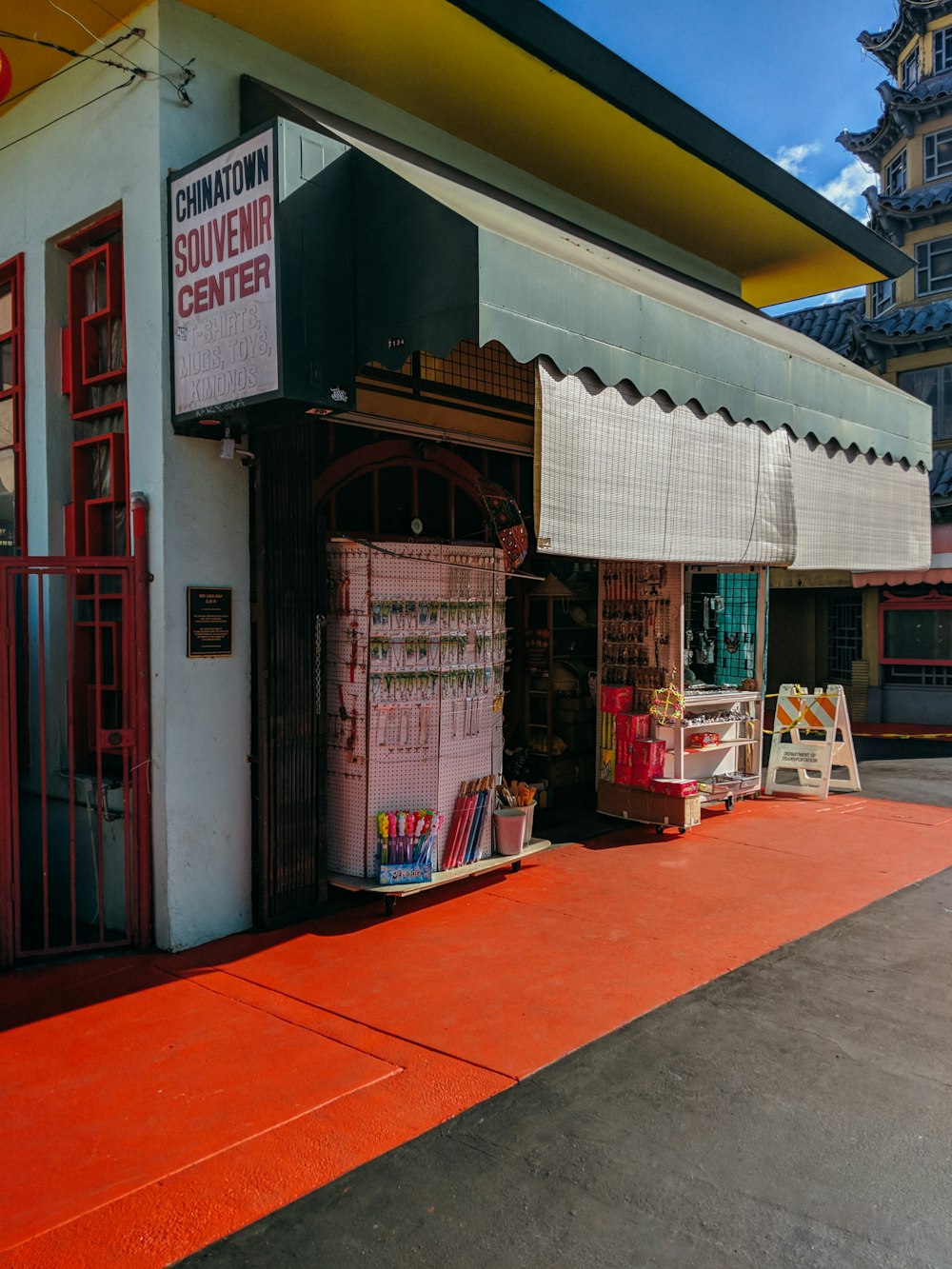 convenient store with green awning under blue sky