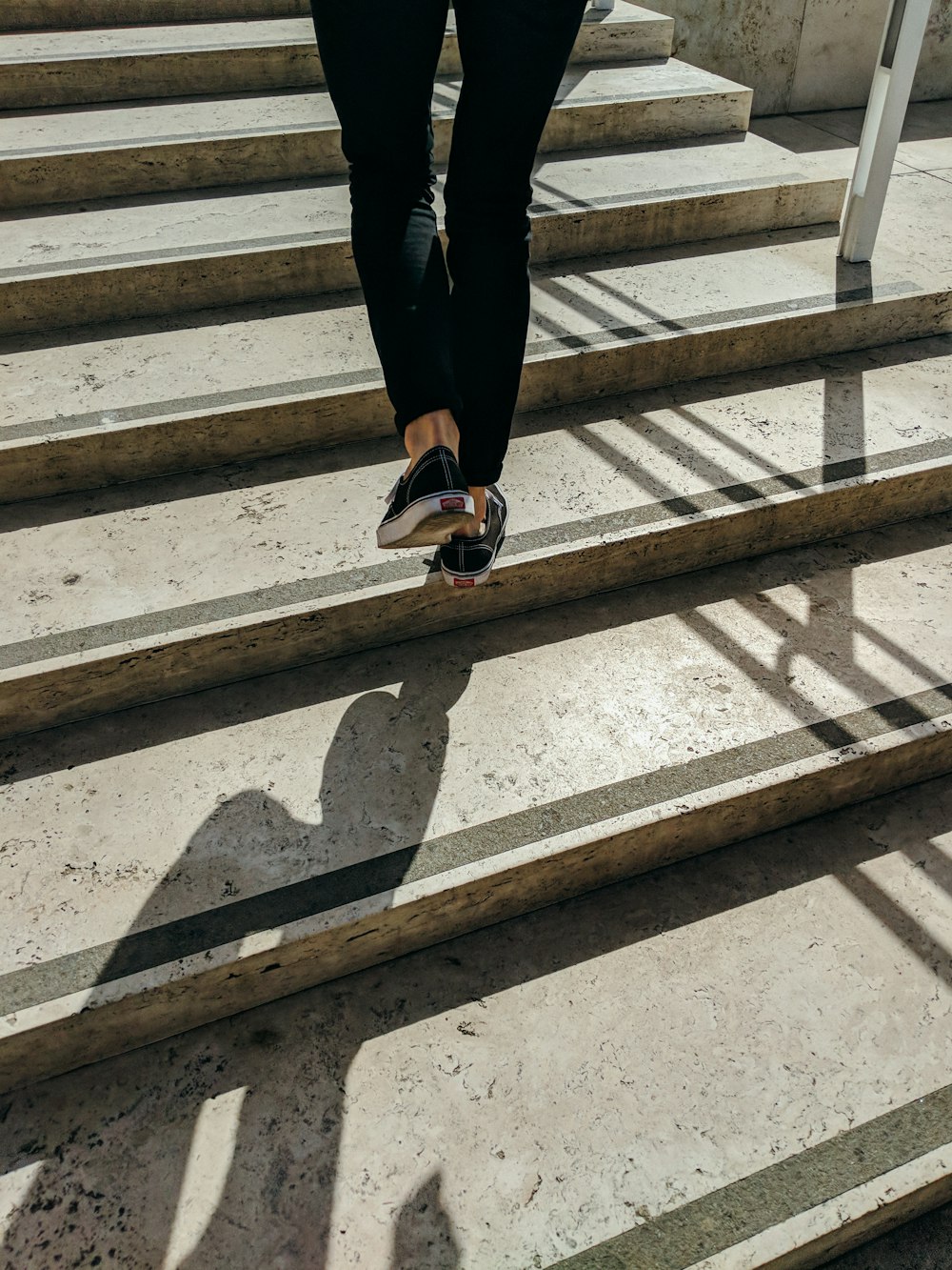 person walking on concrete stair