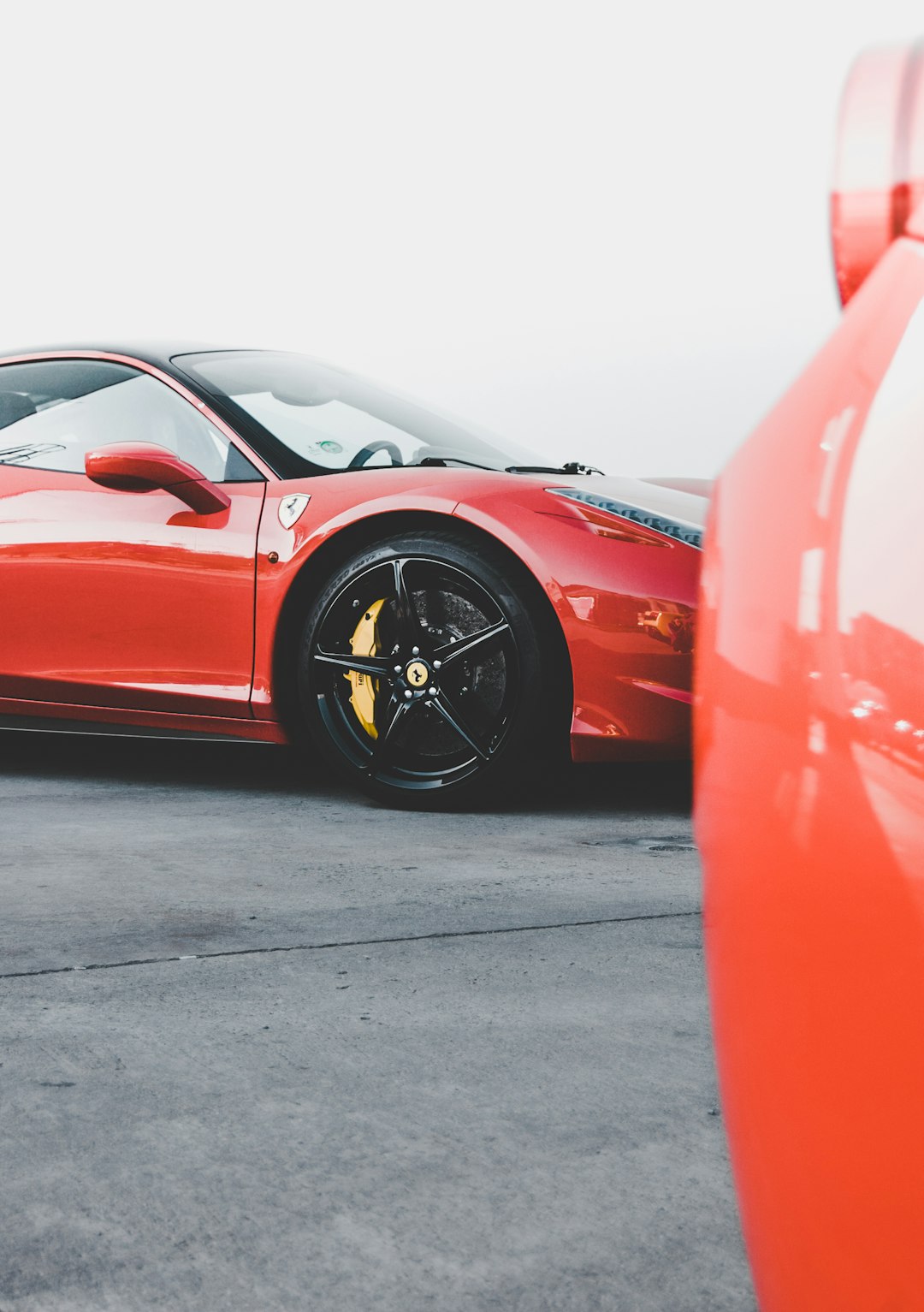 red Ferrari parked on asphalt road