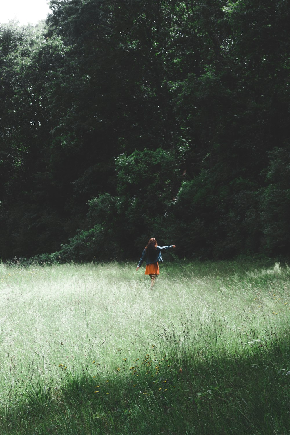 woman standing on grass field at daytime