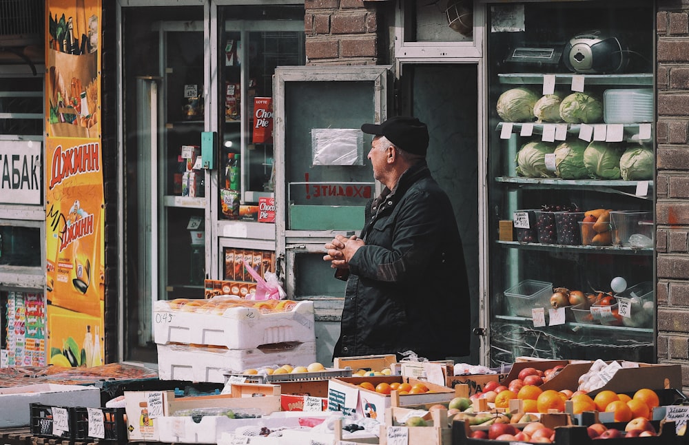 man standing on vegetable stand