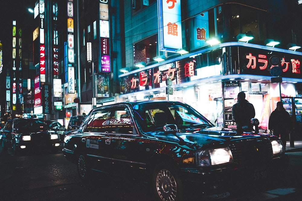 car travelling in city with turned-on light buildings