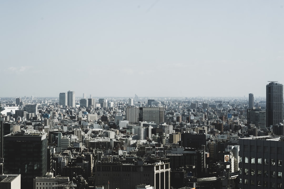 buildings under white clouds,