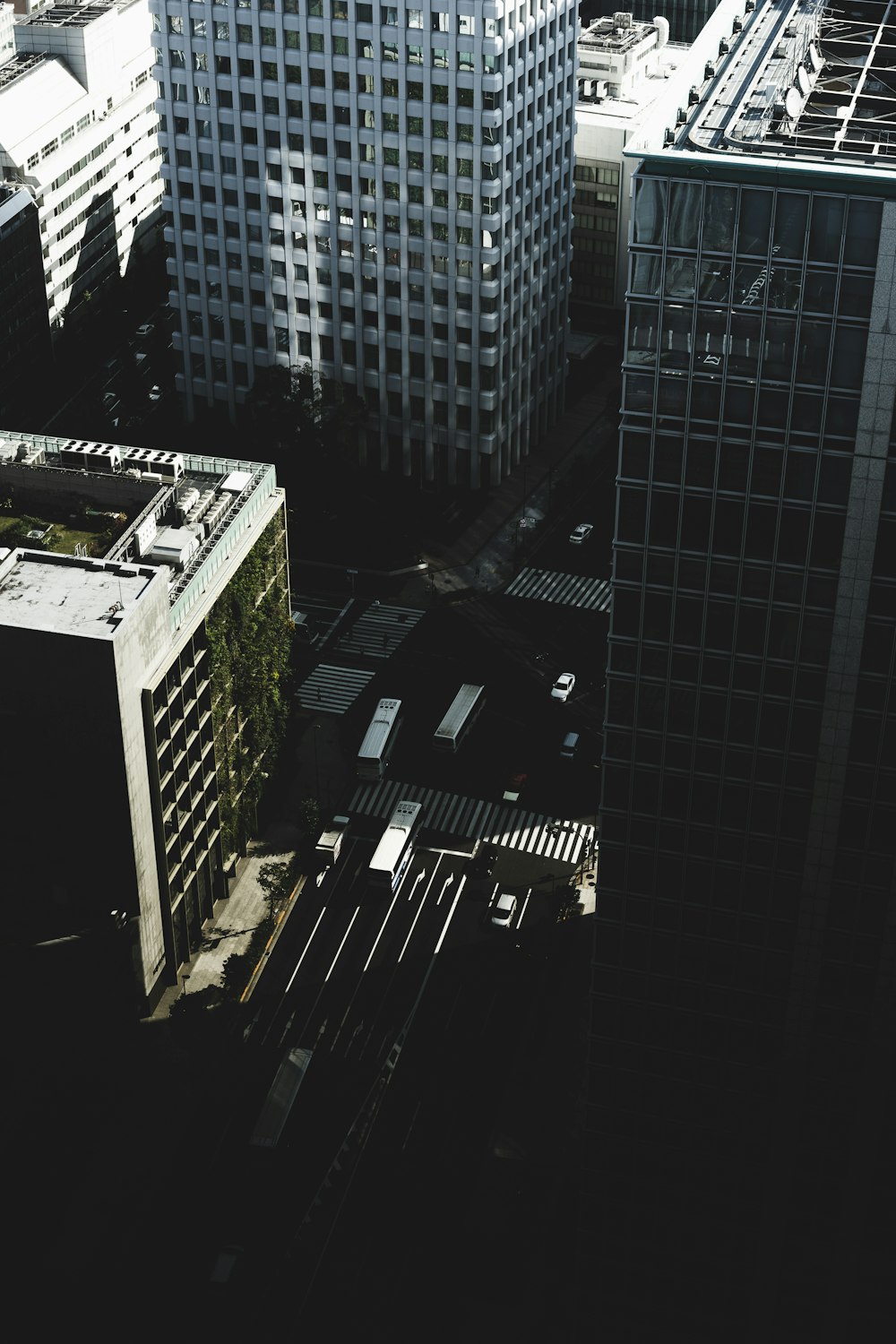 bird's eye view photography of streets and vehicles surrounded by buildings