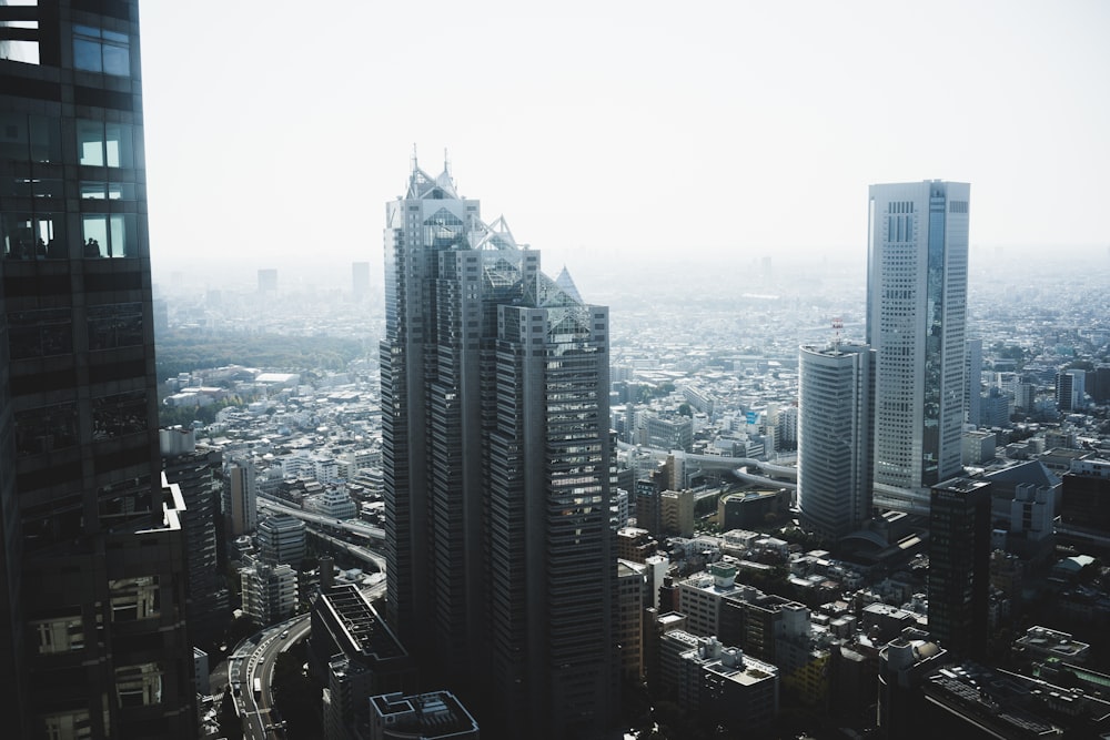 photo of concrete buildings under cloudy sky