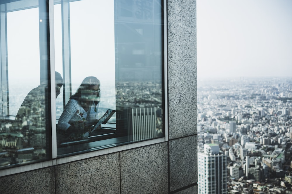 woman standing near window