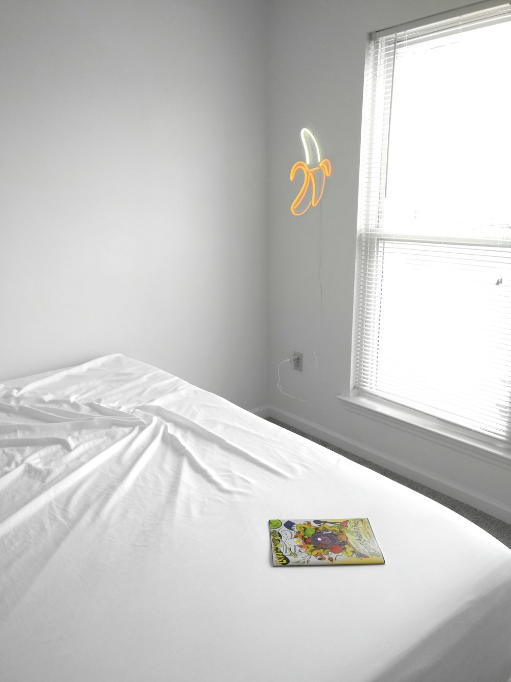 white bed comforter near window