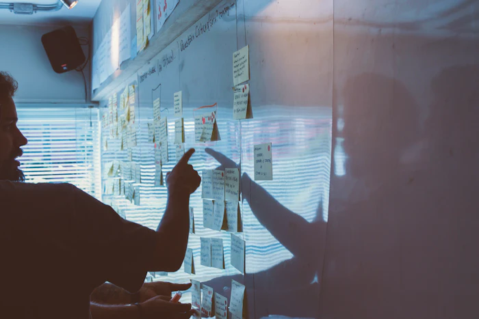 Strategy session, person pointing at wall notes