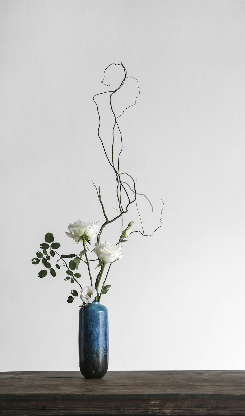 white flowers in blue vase