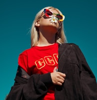 woman with sunglasses standing outdoor during daytime