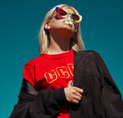 woman with sunglasses standing outdoor during daytime