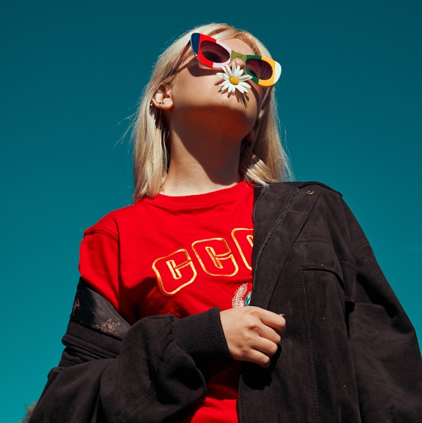 woman with sunglasses standing outdoor during daytime