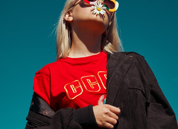 woman with sunglasses standing outdoor during daytime