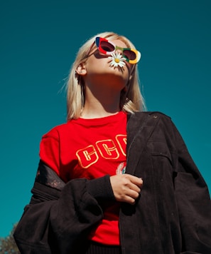 woman with sunglasses standing outdoor during daytime