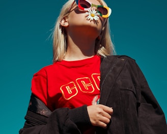 woman with sunglasses standing outdoor during daytime