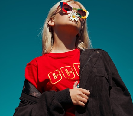 woman with sunglasses standing outdoor during daytime