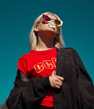 woman with sunglasses standing outdoor during daytime