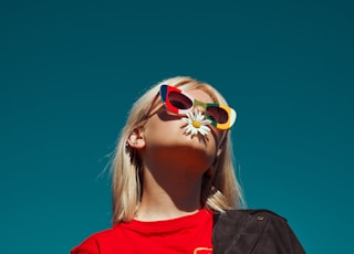 woman with sunglasses standing outdoor during daytime