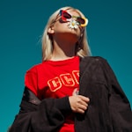 woman with sunglasses standing outdoor during daytime