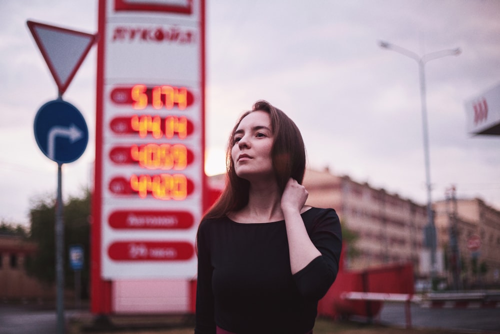 woman near gasoline station