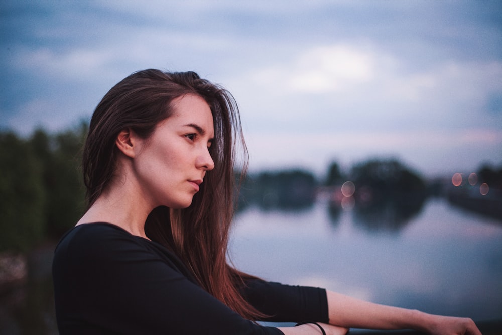 depth photography of woman in 3/4-sleeved top near body of water