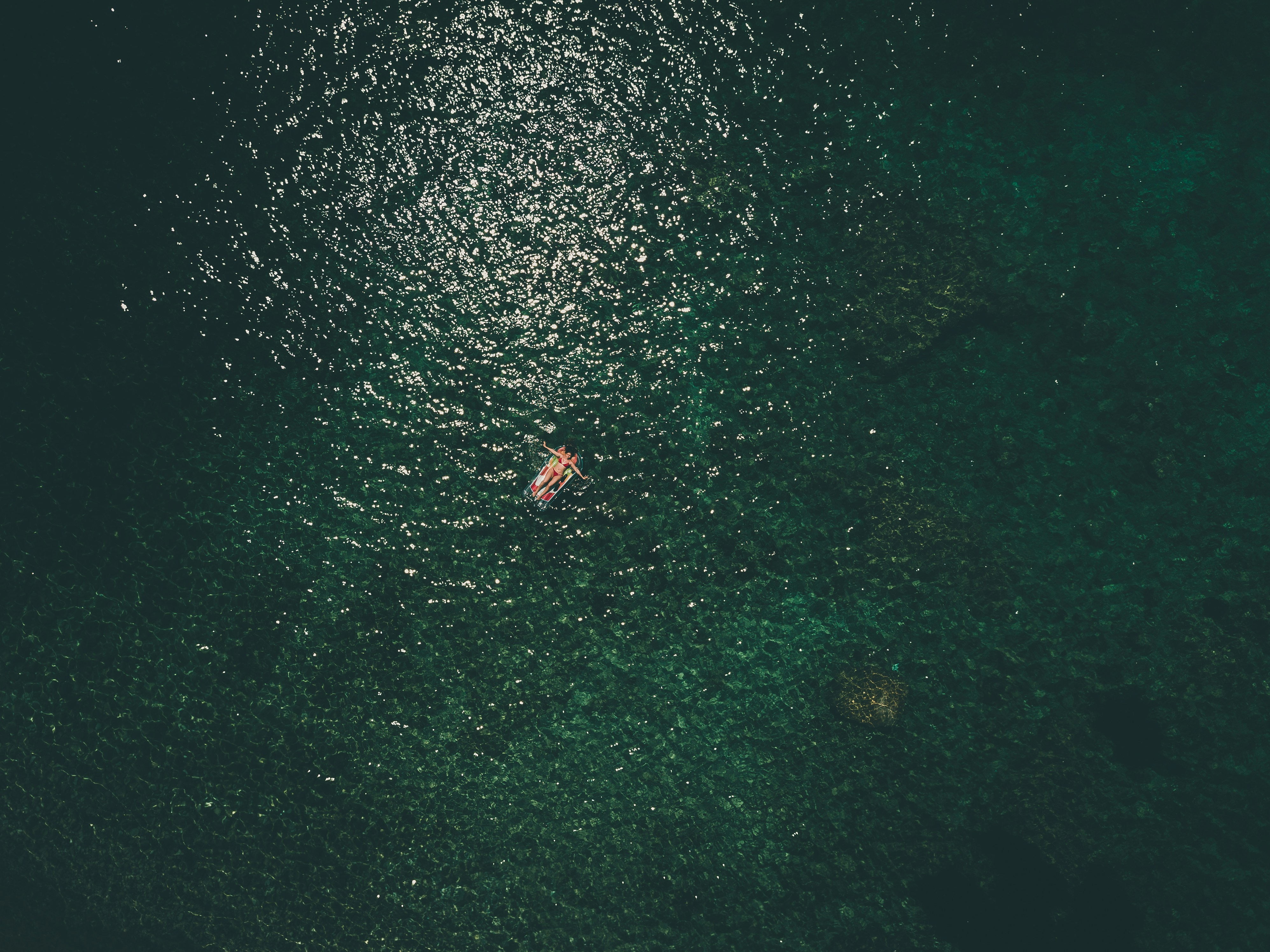 person riding on boat in aerial photogrphy