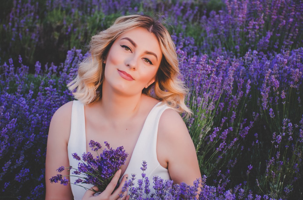 woman wearing white scoop-neck sleeveless top in purple petaled flower field