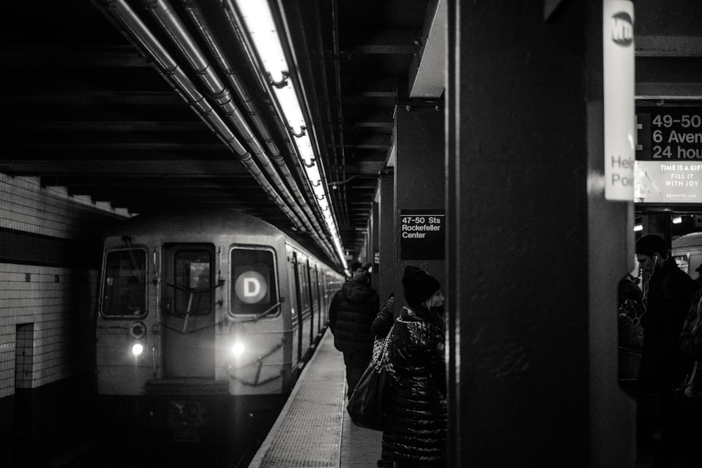 train passing in train station grayscale photography