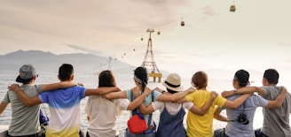 people holding shoulders sitting on wall