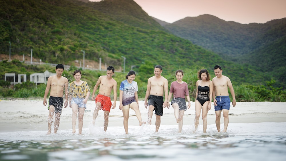 people walking on seashore