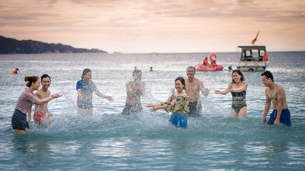 people splashing body of water on sea