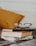 club master eyeglasses on pile of three books