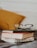 club master eyeglasses on pile of three books