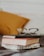club master eyeglasses on pile of three books