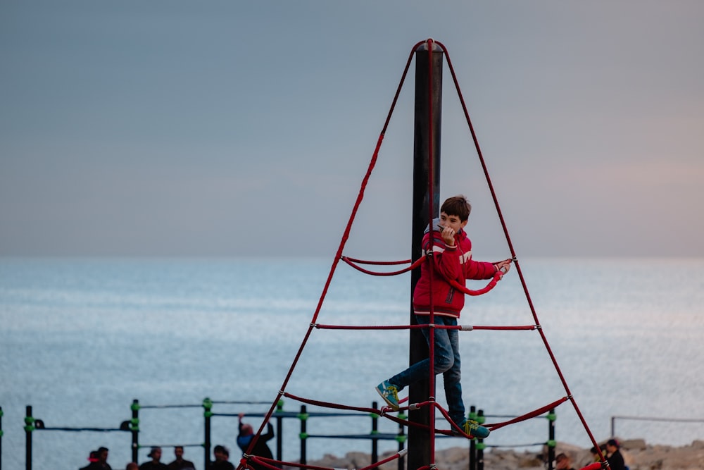 boy climbing on ropes