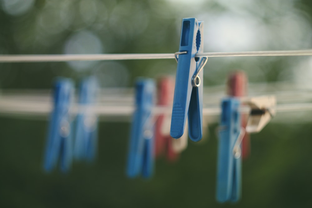 closeup photo of blue clothes peg