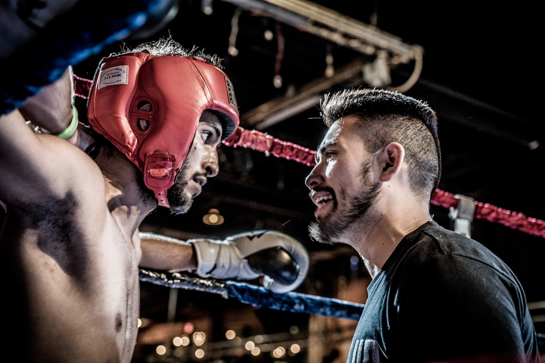 man in black talking to boxer inside ring, My friend Mo was fighting so he invited me to come along. I took this picture