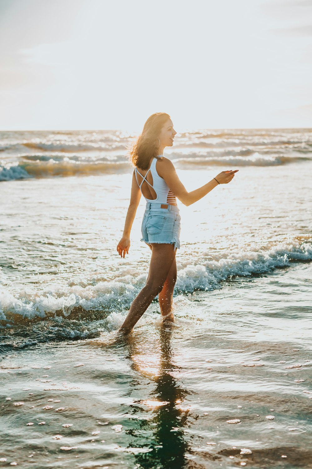 woman walking on seaside during daytime