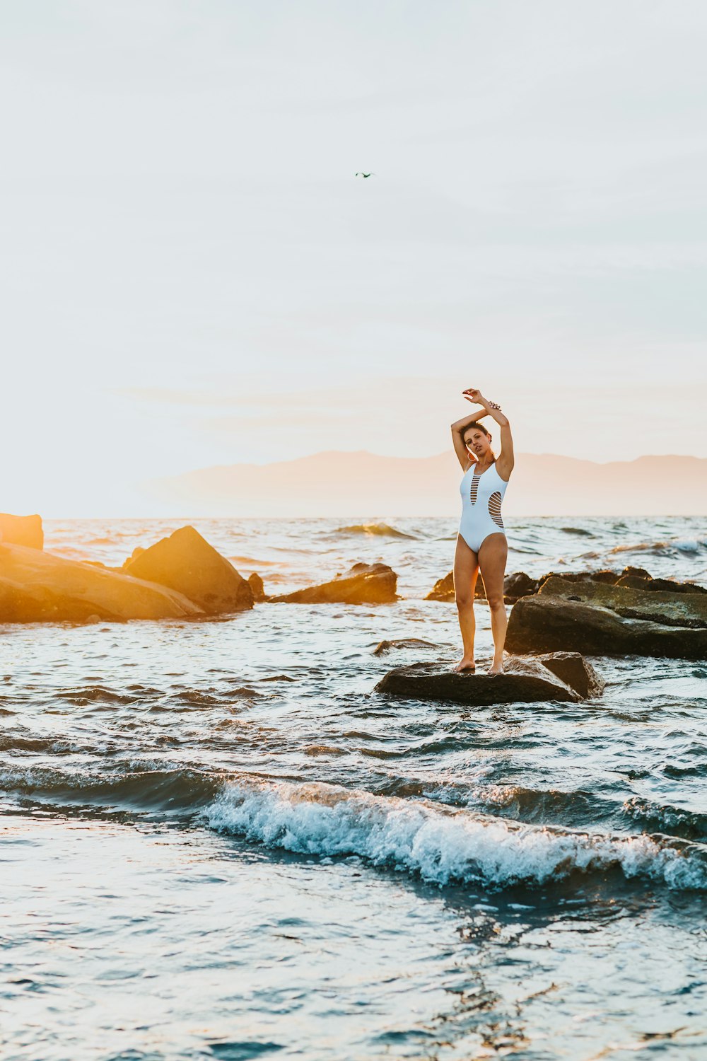 woman standing on rock