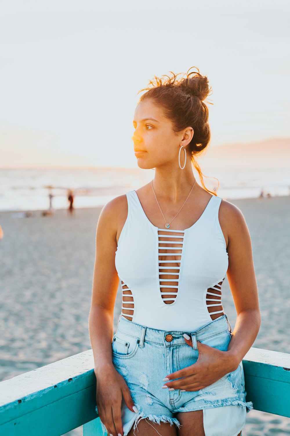 woman standing leaning on fence