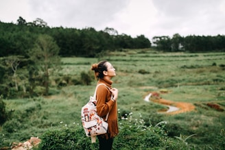 woman standing in the middle of grass field