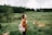 woman standing in the middle of grass field